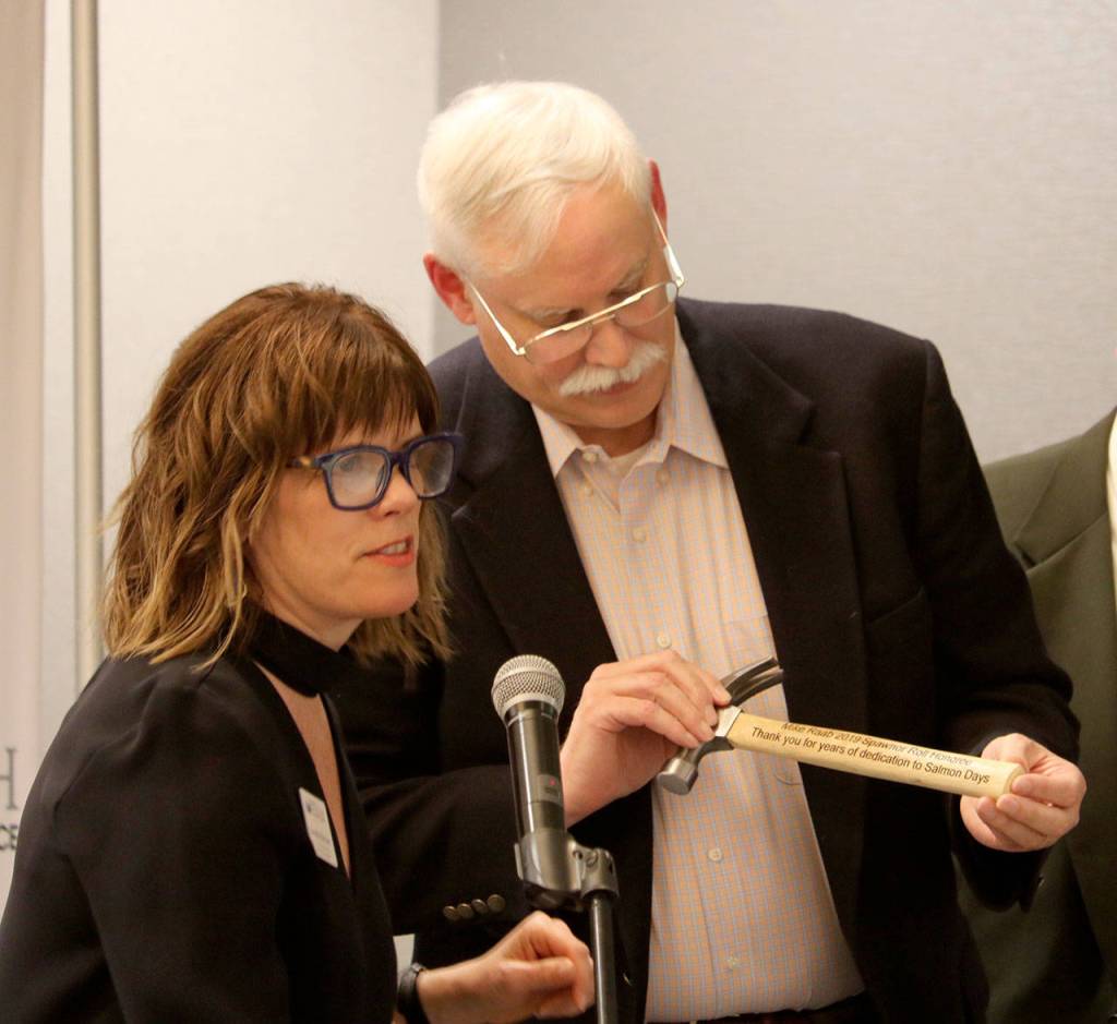 Brenda Devore, left, presented Mike Raab with the Issaquah Chamber Spawnor Roll award for all of the time and effort he puts into Salmon Days.
