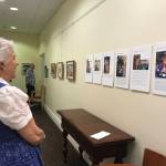 Dianne Miller reads about the artists featured in The Art of Alzheimers exhibit, currently at The Gardens at Town Square.