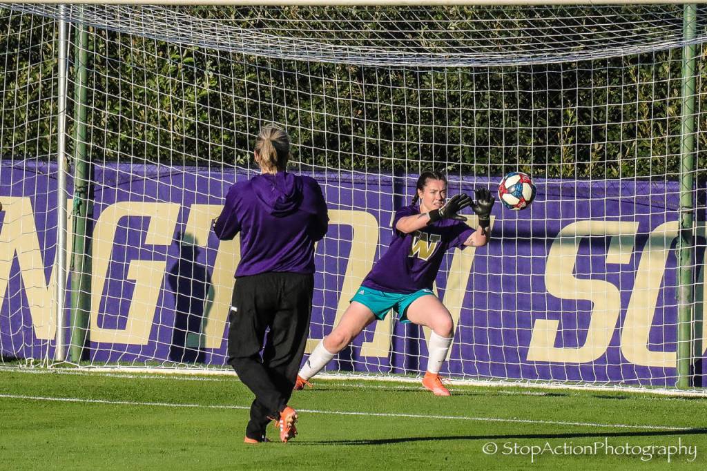 Issaquah High alumnus Anna Miller (right) gets in some practice time before the University of Washington match against Seattle University. Photo courtesy of Don Borin/ Stop Action Photography