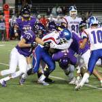 The Issaquah defense swarming the ball in its 20-0 opening-night victory over Kent-Meridian. Benjamin Olson/ staff photo