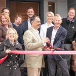 At left: Issaquah Chamber of Commerce held a ribbon cutting at RIVA townhomes on Sept. 24. Front row, from left: Conner Homes team Erin Fowler, Michael Lorenz, Charlie Conner and Libby Thacker; second row: Wendy Romine, Eric Espey, James Yorkston, Queen of Issaquah Katie Bosseler, and the SUHRCO property management team. Natalie DeFord/Staff photo