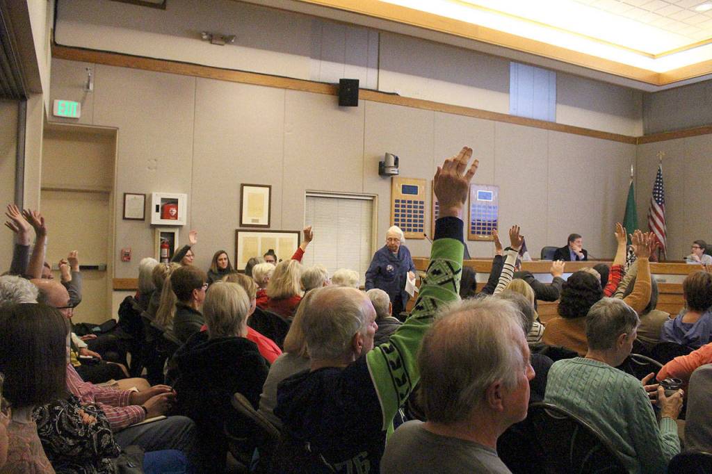 Madison Miller / staff photo                                Supporters of maintaining the recommended zoning for the Providence Heights property raise hands in support of a speaker at the Nov. 12 city council study session.