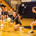 Issaquah outside hitter Abby May kneels to bump the ball during a district tournament game against Newport on Nov. 12. Photo courtesy of Don Borin/Stop Action Photography