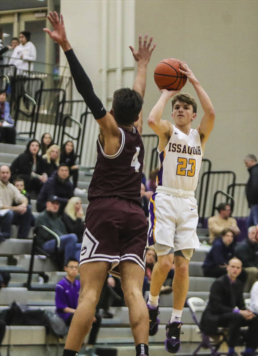 Issaquah guard Timmy Crandall (right) scored 11 points in the Eagles 62-54 loss to Mercer Island on Dec. 4. Photo courtesy of Don Borin/Stop Action Photography