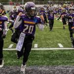 Jack Rooney (45) and John Baumann (20) run through a sign before the championship game on Nov. 16. Photo courtesy of Tricia Barry