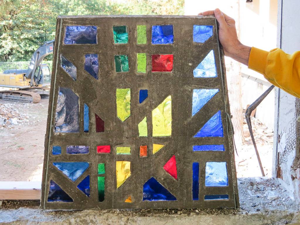 Nicholas Frei holds up a segment of one of the Providence Heights College chapels 14 windows. Each window has 38 segments, so more than 500 segments had to be deconstructed, packaged and catalogued. Courtesy of Sisters of Providence, Mother Joseph Province.