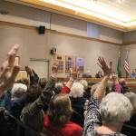 Madison Miller/staff photo                                Providence Point residents raise hands in support of a Providence Point speaker at the Jan. 21 city council meeting.