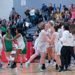 The Issaquah girls basketball team celebrates its 67-50 win over Kentwood in a loser-out regional playoff game on Feb. 29 at Sammamish High School. The win secured the Eagles a spot in the 4A state tournament. Photo courtesy of Patrick Krohn/Patrick Krohn Photography