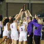 The Issaquah Eagles hoist the fourth-place trophy after beating Todd Beamer in the girls 4A state basketball tournament on March 7 at the Tacoma Dome. Benjamin Olson/staff photo