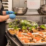 James Gasser with Lisa Dupar Catering prepares sandwiches, part of the boxed lunches that will be delivered to first responders working at COVID-19 testing sites. Photo courtesy of Hannah Sheil