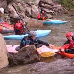 Eleanor Knight, 14, and her younger brother, Ivan, then, 9, horse around while waiting to surf a wave on the Class III Wenatchee River. Courtesy photo.