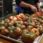 Sarah Cassidy and Chef Kyle Bopes prep heirloom tomatoes from Hearth Farm. Photo by Cameron Sheppard/Sound Publishing