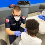 A Puget Sound Fire employee administers a COVID-19 shot Dec. 1 to a Tahoma School District student. COURTESY PHOTO, Puget Sound Fire