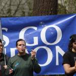 A member of the crowd blows bubbles in front of a giant LETS GO BRANDON sign as the crowd awaits the arrival of President Biden. Photo by Alex Bruell/Sound Publishing