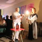 High Priest Kalu and High Preistess Syleena Call The Corners, a small ritual where a candle is lit at each direction of the Earth as the elements of each direction is called upon. Here they call on the guardian of the watchtower of the South, represented by red which symbolizes fire. Photo by Bailey Jo Josie/Sound Publishing.