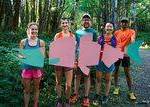 Runners hold cardboard salmon in support of the Save Coal Creek campaign. (Photo courtesy of Kelly Jiang)