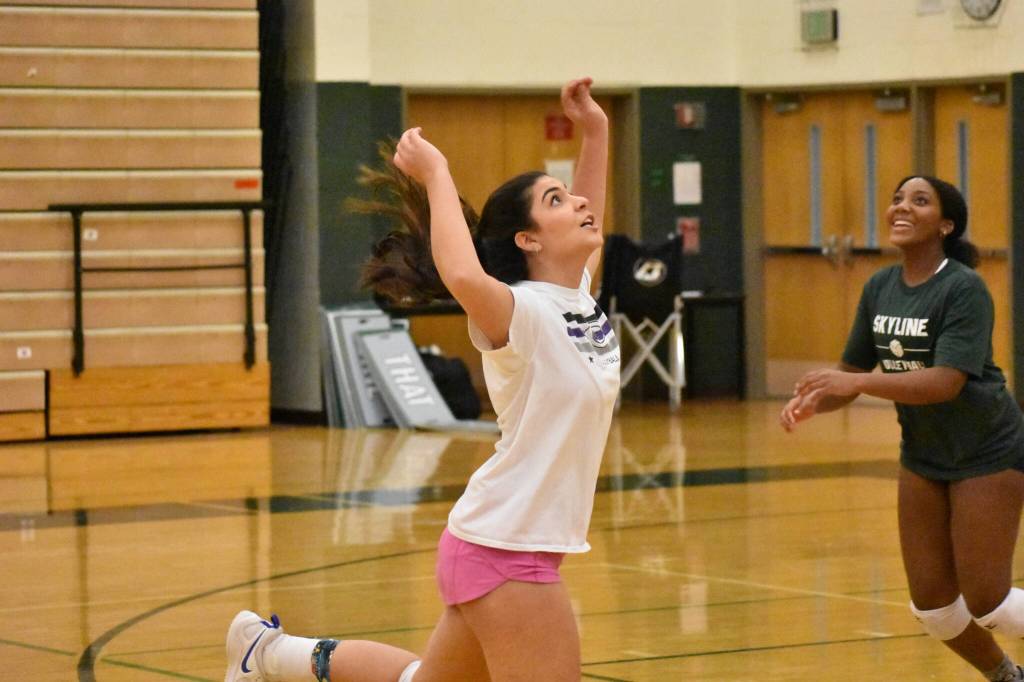 Gianna Valdez keeps a play alive and Savannah Fisher smiles in the background. Ben Ray / The Reporter