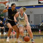 Ella Whitaker looks to go past a Wolverine defender. Ben Ray / The Reporter