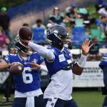 All three quarterbacks getting loose, with Seahawks starter Geno Smith front and center. Photos by Ben Ray / Sound Publishing