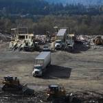 Trucks unload waste onto Cell 8. Photo by Bailey Jo Josie/Sound Publishing.