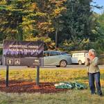 King County Councilmember Sarah Perry unveils the new Issaquah trailhead marker named after her late husband Sen. Bill Ramos, Oct. 6, 2025. Photo courtesy of Sarah Perry