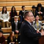 Washington State Office of Superintendent of Public Instruction (OSPI) Head Chris Reykdal speaks at the regional education funding town hall on Jan. 7 at Newport High School in Bellevue as copious student speakers sit in the background awaiting their turns at the mic. Andy Nystrom/ staff photo
