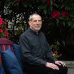 Photo by Moe K. Clark/InvestigateWest
Joel Levin, the co-founder and director of programs for the Seattle-based nonprofit Stop Sexual Assault in Schools, poses for a portrait outside his home on May 17, 2026. Levin co-founded his nonprofit in 2015 after a family member was sexually assaulted by a peer on a school field trip.